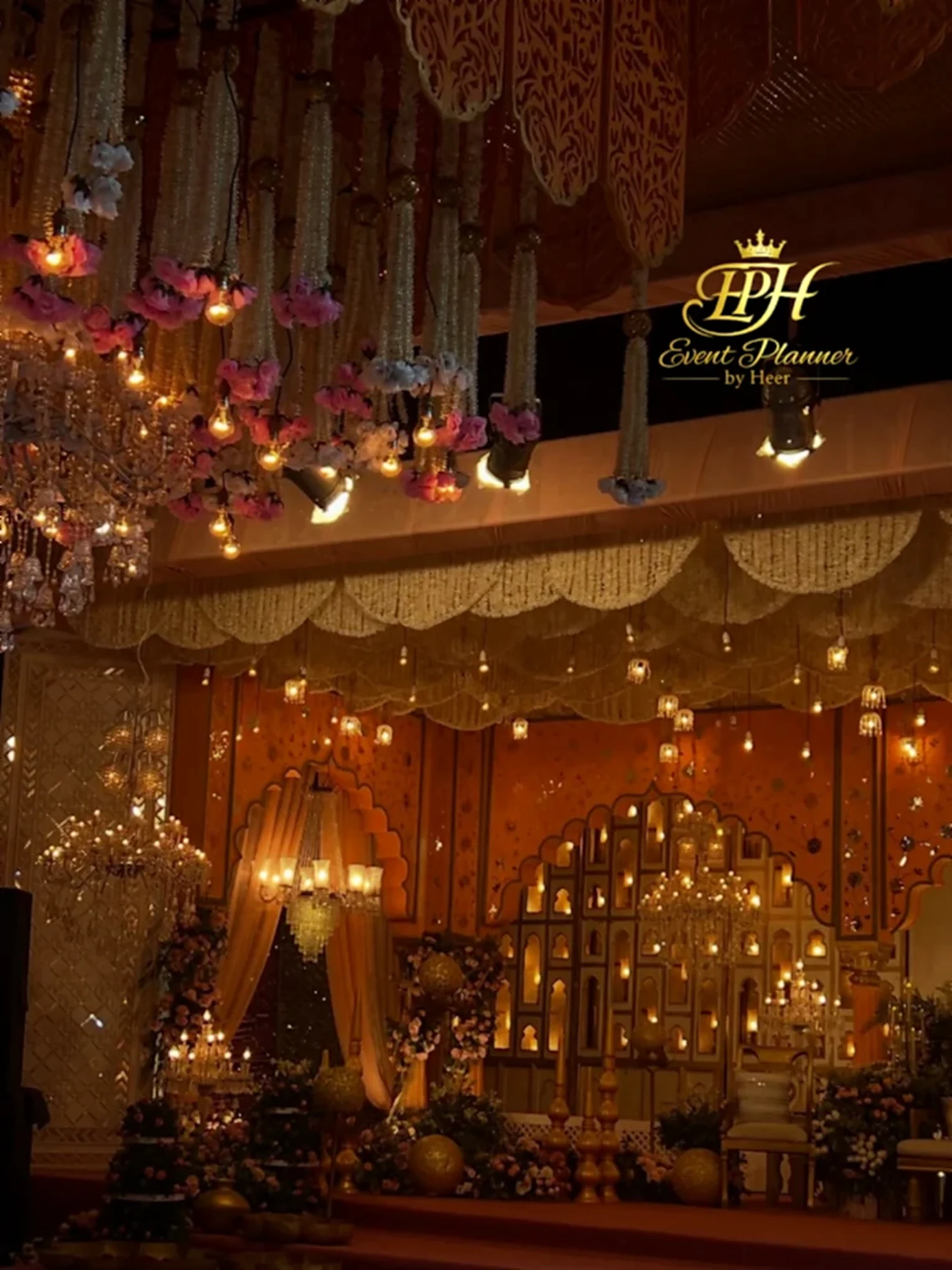 Illuminated wedding mandap with chandeliers and floral canopy styled by Event Planner by Heer in Gujranwala